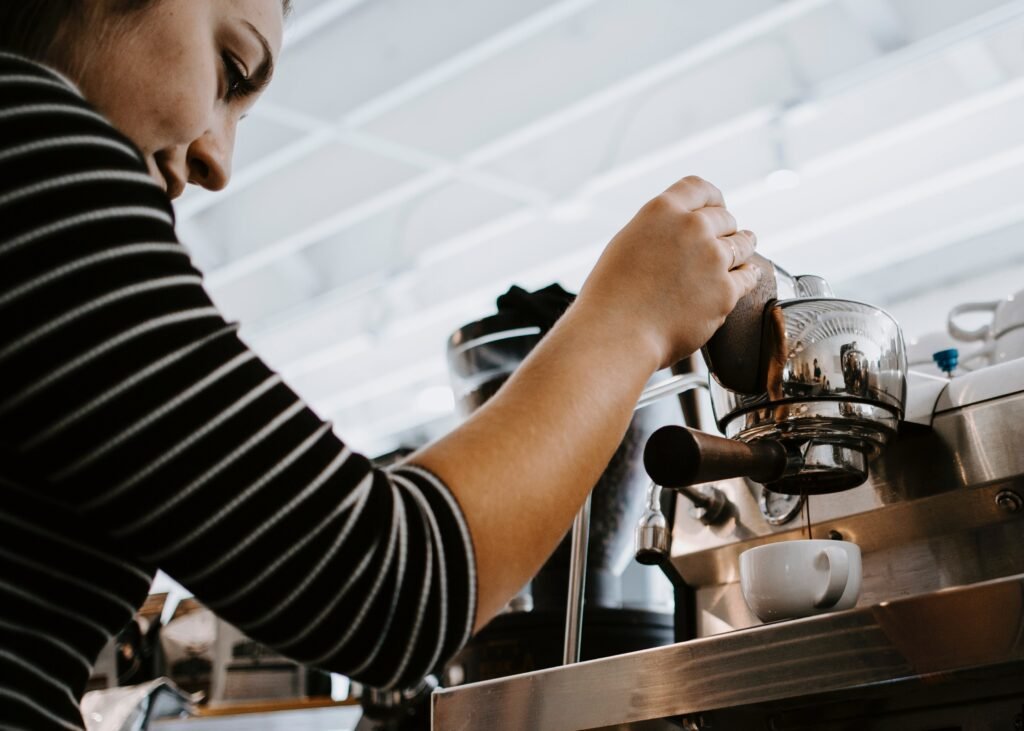 person making morning coffee