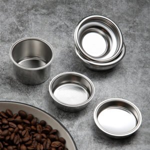 A close-up of a custom 58mm filter basket showing its precision-engineered holes, resting next to coffee beans