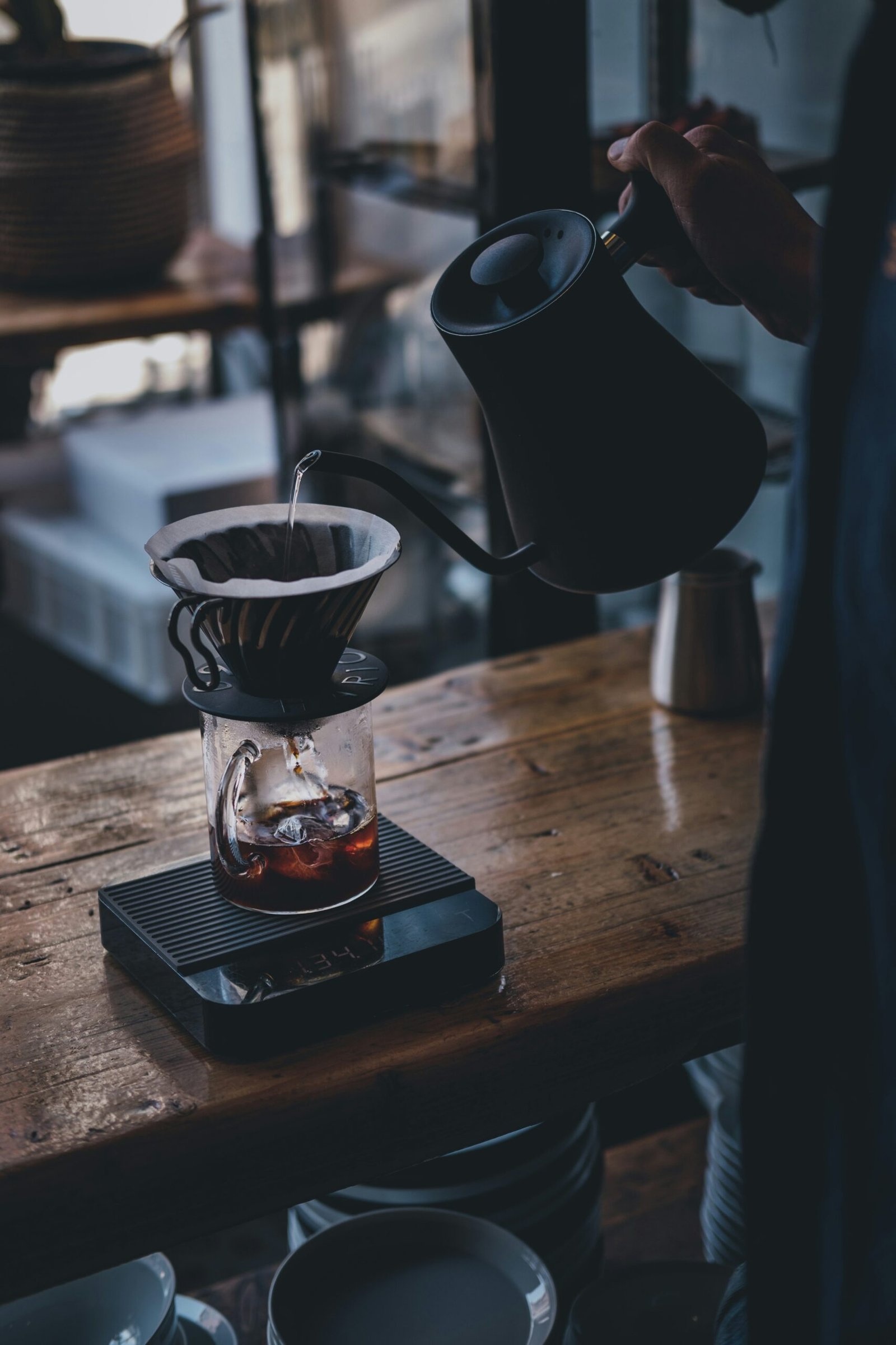 Pour over coffee setup next to an espresso machine portafilter