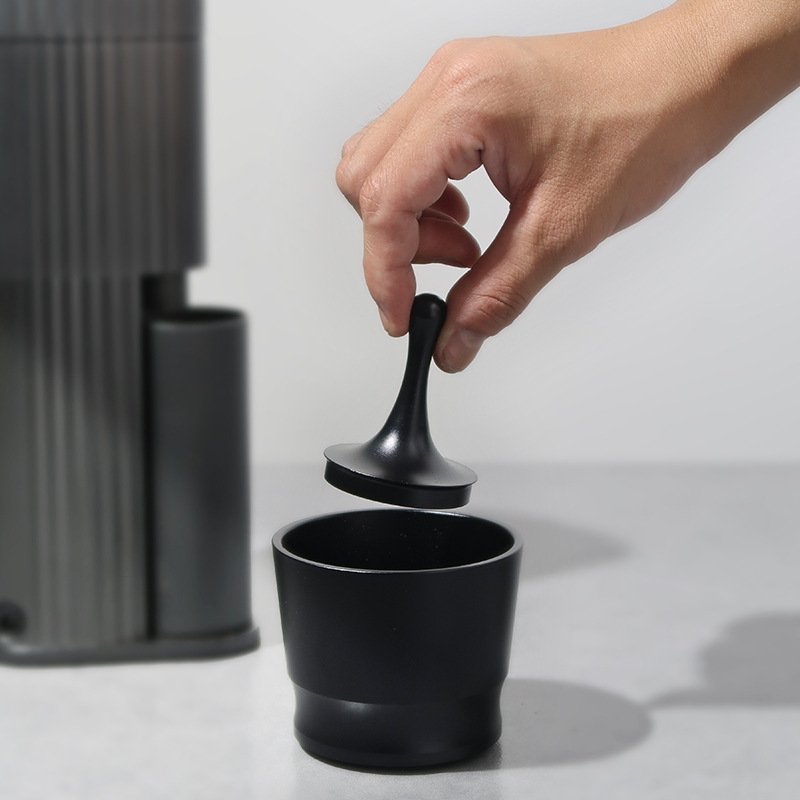 Portafilter funnel placed on espresso machine portafilter