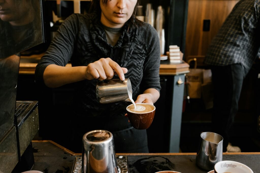 Practicing latte art techniques person practicing latte art pouring technique