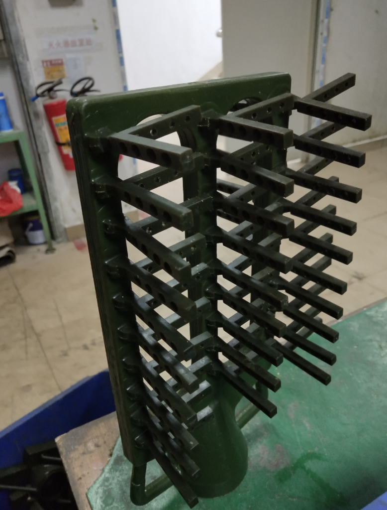 A wax model of a coffee portafilter head