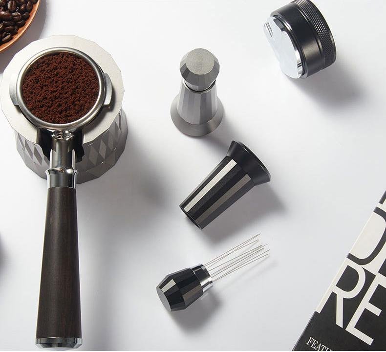 Professional barista demonstrating proper coffee tamping technique to prevent grounds sticking to portafilter