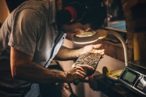 Premium coffee roaster examining freshly roasted beans for quality assessment