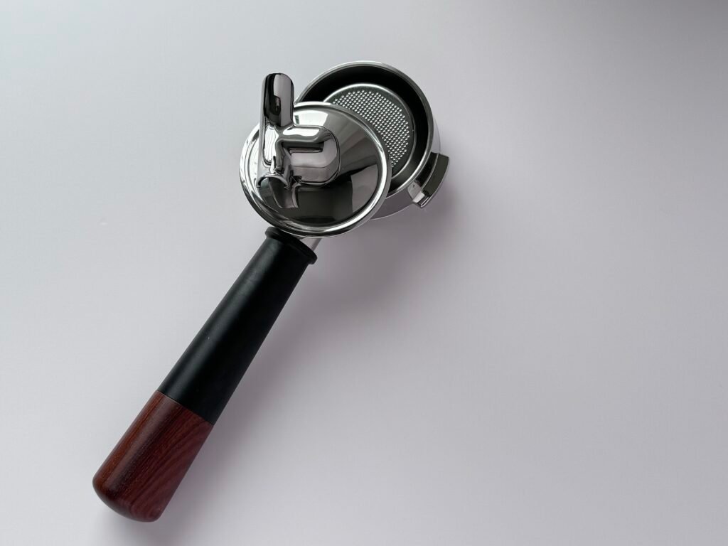 Barista demonstrating extraction with a 2-in-1 portafilter, showing the quick switching process