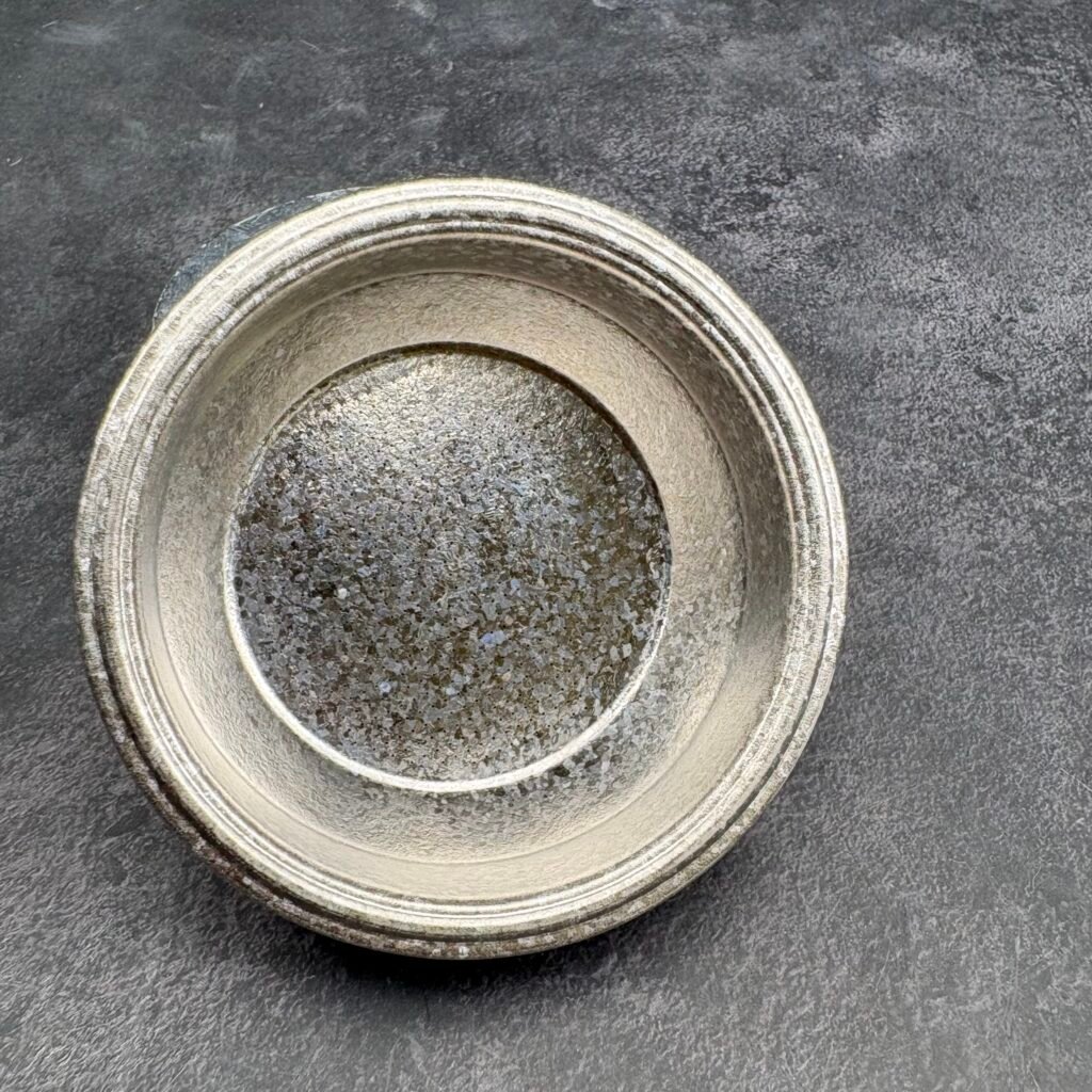 close-up of titanium basket perforation pattern showing uniform hole distribution